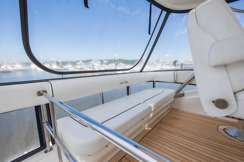 Slide: The Image of 2008 Sea Ray 58 Sedan Bridge interior with white seating and panoramic windows. - 23