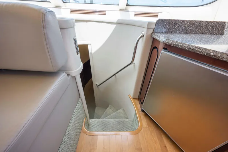 Slide: The Image of Interior of 2008 Sea Ray 58 Sedan Bridge, featuring stairs and compact kitchen area. - 39