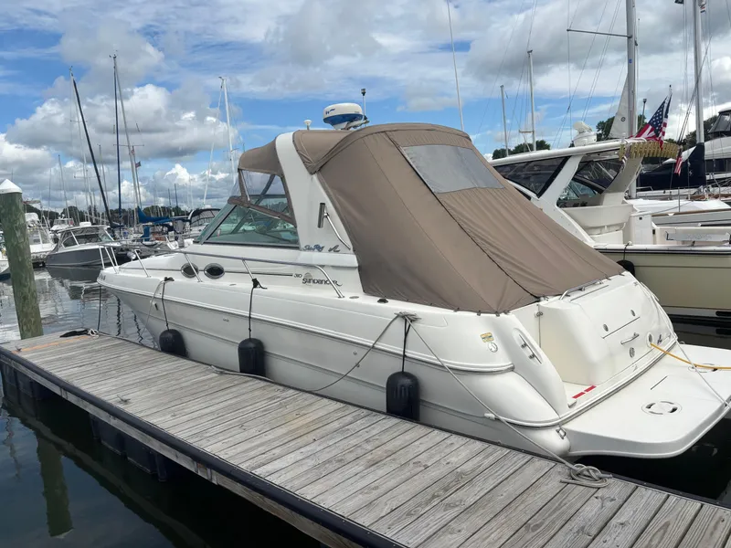 The Image of 2000 Sea Ray 310 Sundancer docked at marina under cloudy sky. - 0