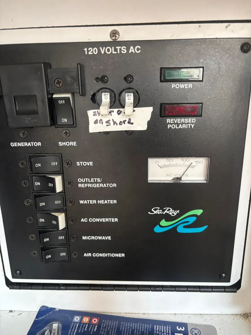 Slide: The Image of Electrical control panel of a 2000 Sea Ray 310 Sundancer boat, showing switches and voltage meter. - 10