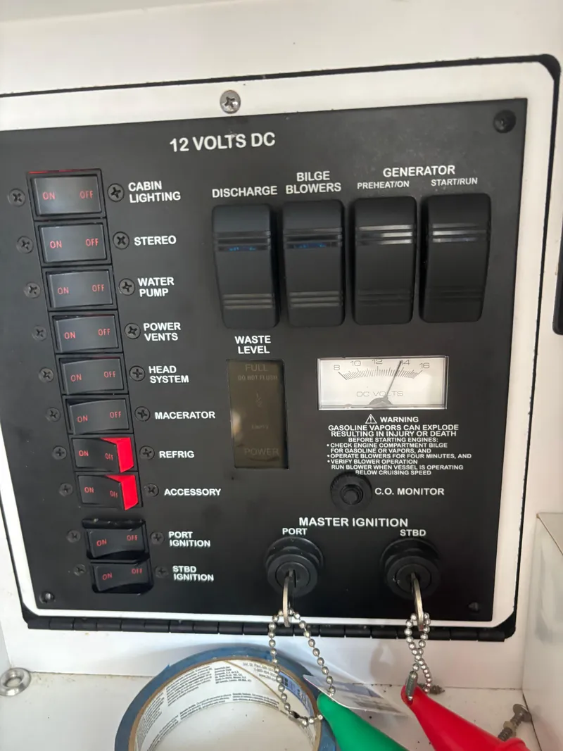 Slide: The Image of Control panel of a 2000 Sea Ray 310 Sundancer boat, showing switches and gauges. - 11