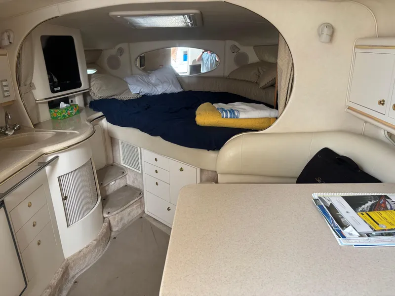 Slide: The Image of Interior of 2000 Sea Ray 310 Sundancer with cozy cabin and kitchenette. - 12