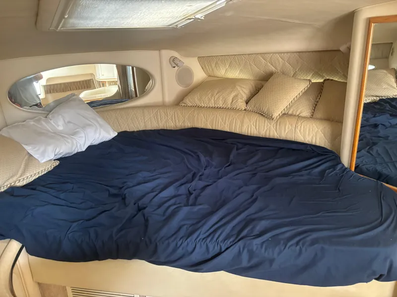 Slide: The Image of Interior cabin of 2000 Sea Ray 310 Sundancer with bed and pillows. - 14
