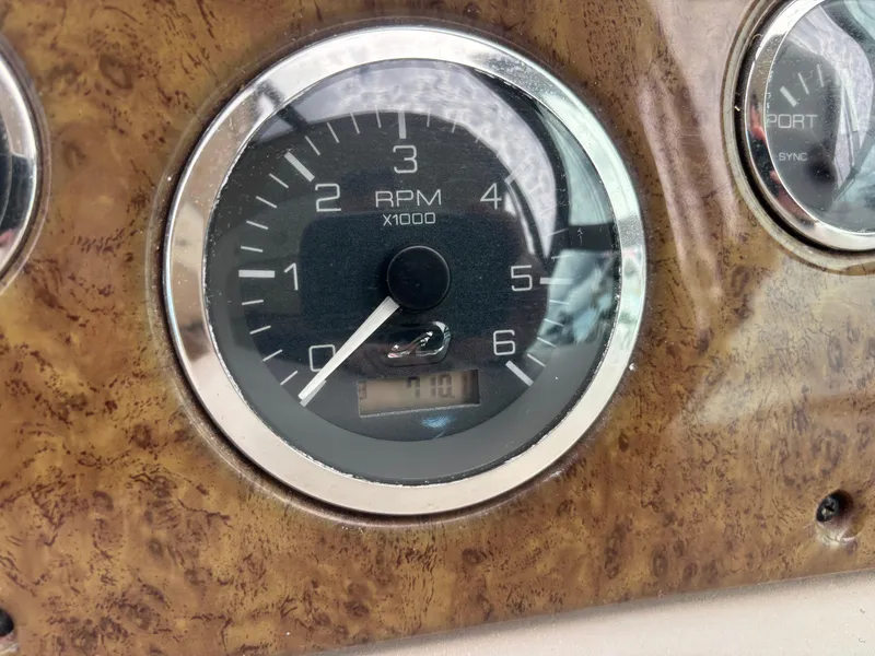 Slide: The Image of Tachometer of 2000 Sea Ray 310 Sundancer showing RPM on wooden dashboard. - 23
