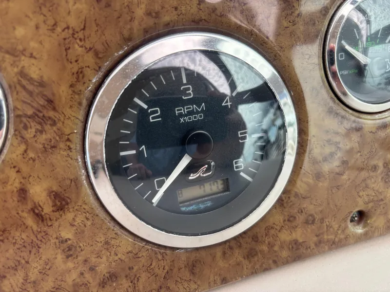 Slide: The Image of Tachometer of 2000 Sea Ray 310 Sundancer boat, showing RPM gauge on wood panel. - 24