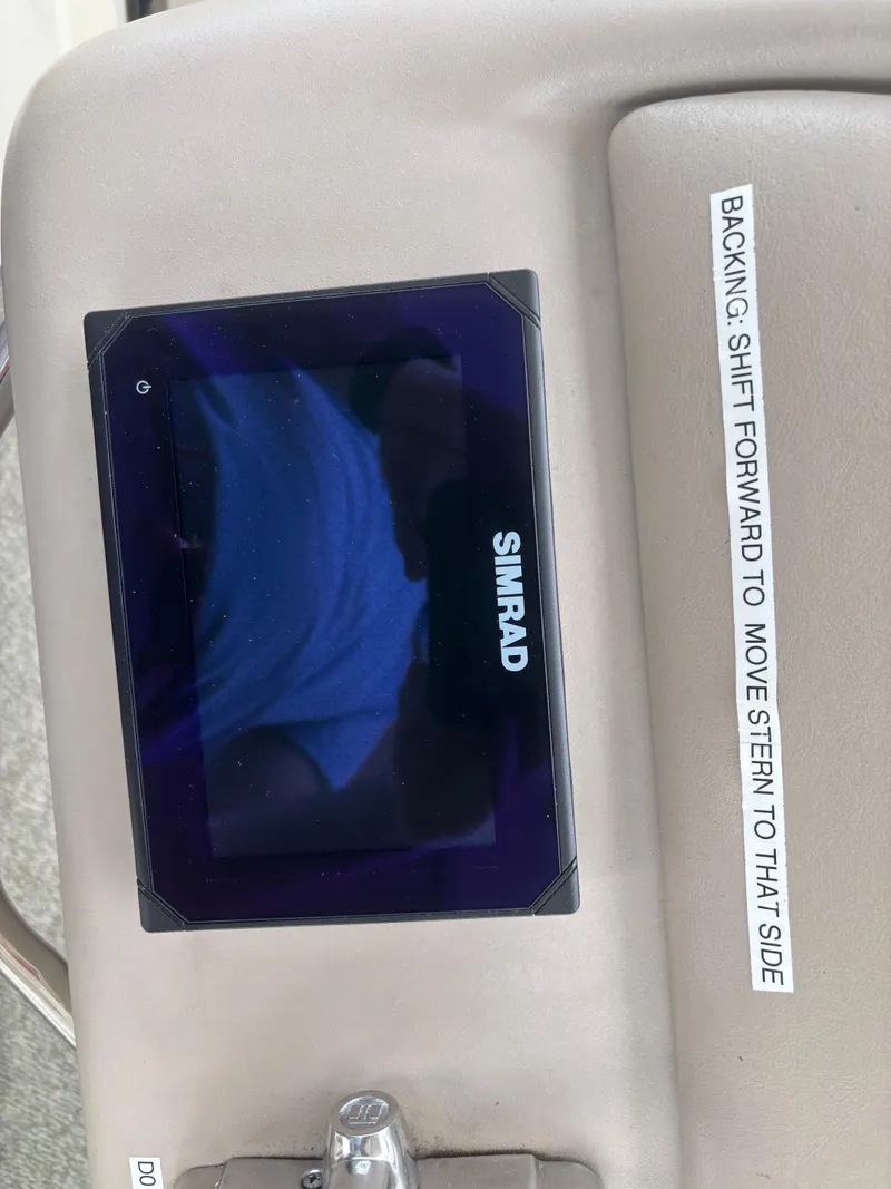 Slide: The Image of Simrad display on 2000 Sea Ray 310 Sundancer boat dashboard with navigation instructions. - 25
