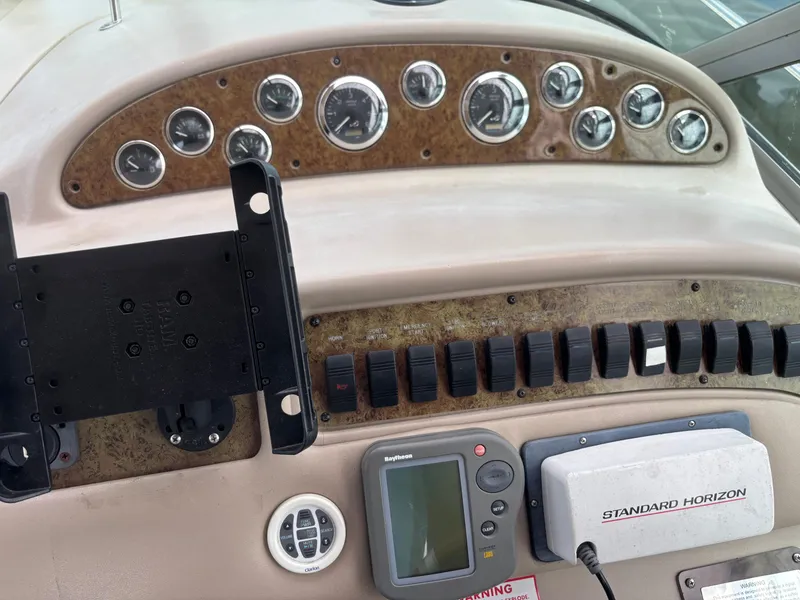 Slide: The Image of Control panel of a 2000 Sea Ray 310 Sundancer boat with gauges and navigation equipment. - 26