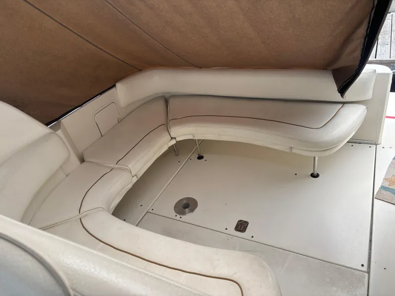 Slide: The Image of 2000 Sea Ray 310 Sundancer interior with beige leather seating and canopy. - 5