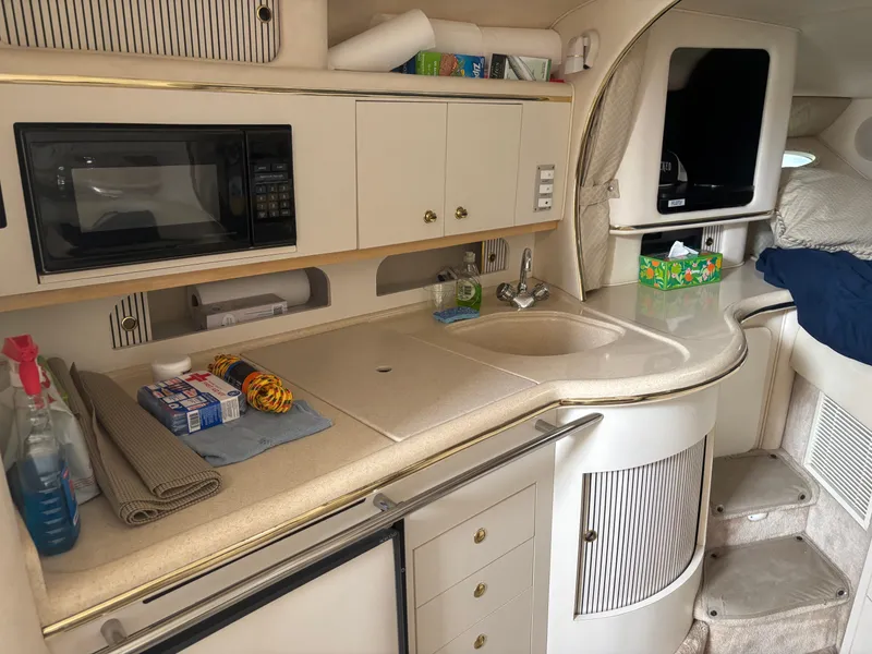Slide: The Image of Interior of 2000 Sea Ray 310 Sundancer yacht with kitchenette and storage. - 6