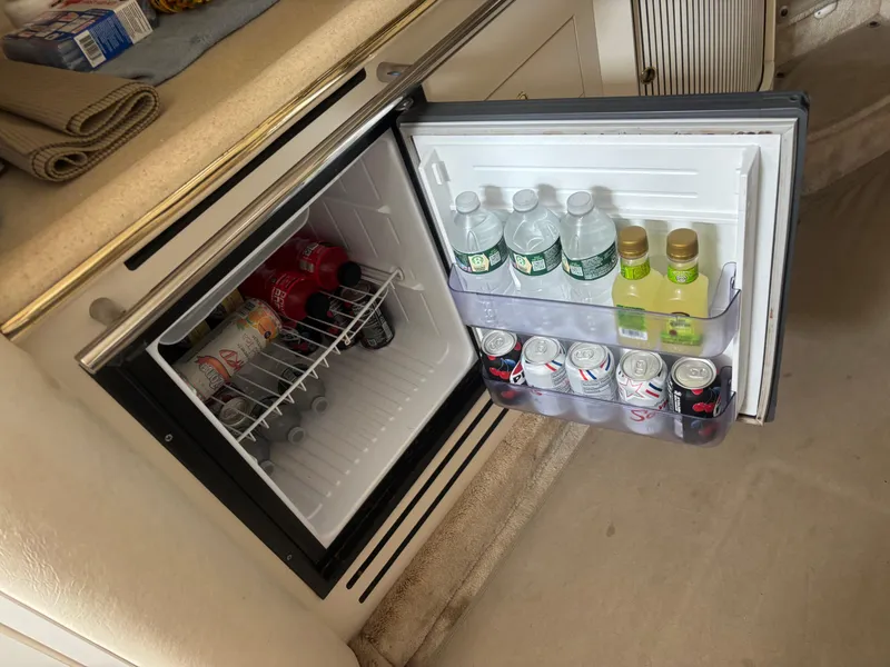Slide: The Image of Mini fridge stocked with drinks on a 2000 Sea Ray 310 Sundancer boat. - 8