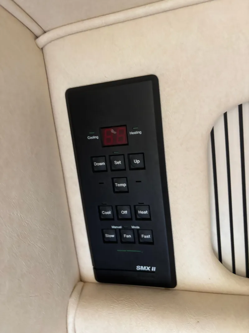 Slide: The Image of Control panel on a 2000 Sea Ray 310 Sundancer boat, featuring temperature settings. - 9