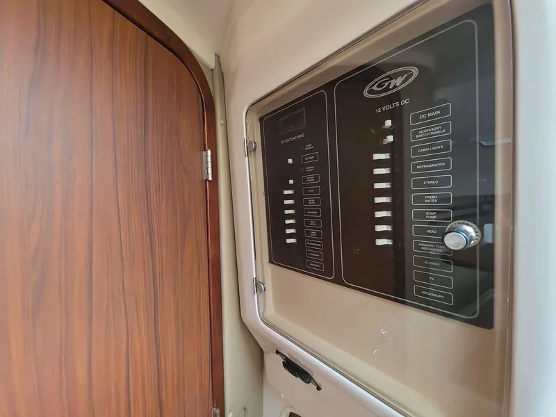 Slide: The Image of 2024 Grady-White Marlin 300 control panel with wooden door detail. - 14