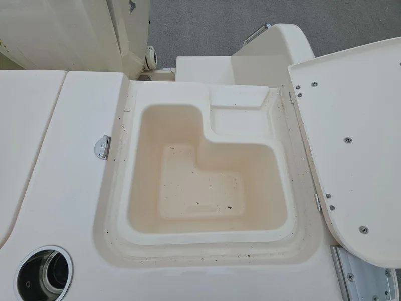 Slide: The Image of 2024 Grady-White Marlin 300 boat storage compartment, open lid, clean interior. - 16