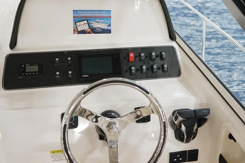 Slide: The Image of Manufacturer Provided Image: 2024 Grady-White Marlin 300 helm with steering wheel and control panel. - 27