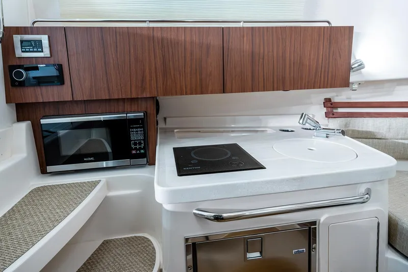 Slide: The Image of Manufacturer Provided Image: 2024 Grady-White Marlin 300 boat kitchen with microwave, stove, and sink. - 32