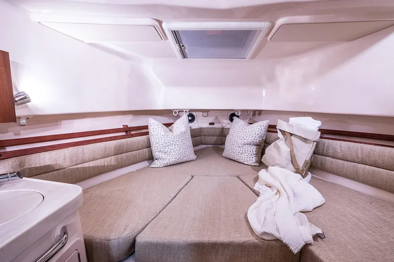 Slide: The Image of Manufacturer Provided Image: 2024 Grady-White Marlin 300 cabin interior with beige cushions and pillows. - 35