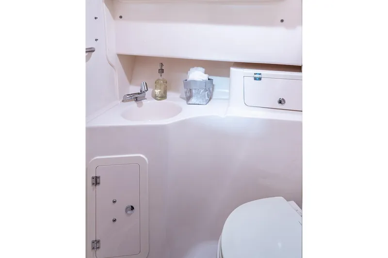 Slide: The Image of Manufacturer Provided Image: 2024 Grady-White Marlin 300 boat bathroom with sink and toilet. - 36