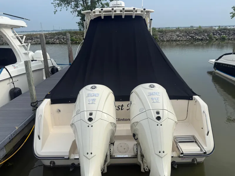 Slide: The Image of 2024 Grady-White Marlin 300 with twin outboard engines docked at marina. - 7