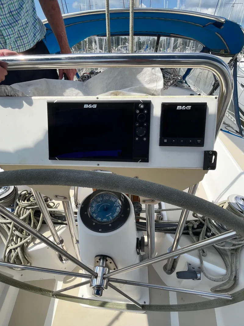Slide: The Image of 1994 J Boats J 40 yacht cockpit with steering wheel and navigation instruments. - 11