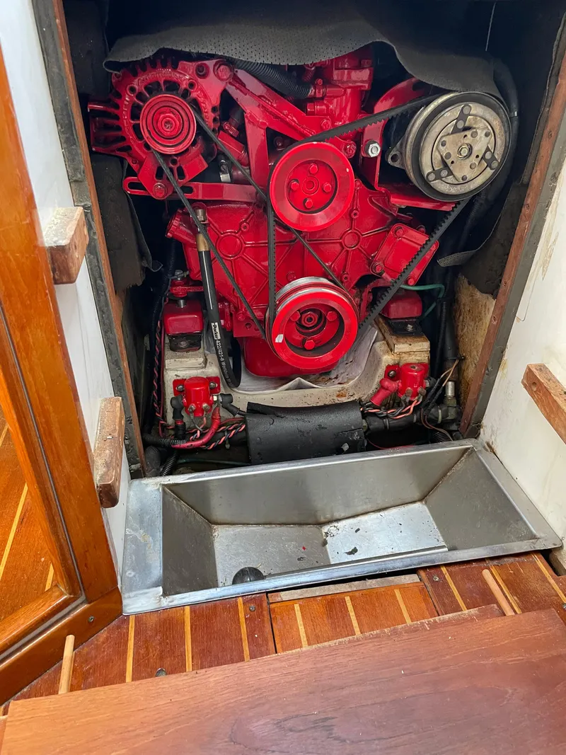 Slide: The Image of Engine compartment of a 1994 J Boats J 40 sailboat, featuring a red engine. - 16
