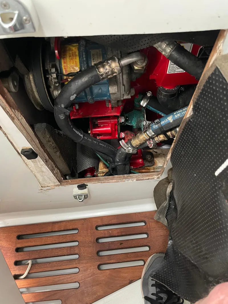 Slide: The Image of Engine compartment of a 1994 J Boats J 40 sailboat, showing hoses and mechanical components. - 17