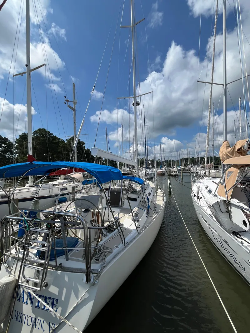 Slide: The Image of 1994 J Boats J 40 sailboat docked in a marina under a blue sky. - 18