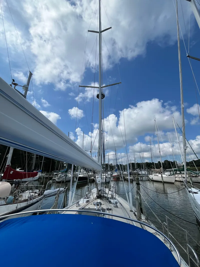 Slide: The Image of Sailboat J Boats J 40, 1994 model, docked under a blue sky with clouds. - 19