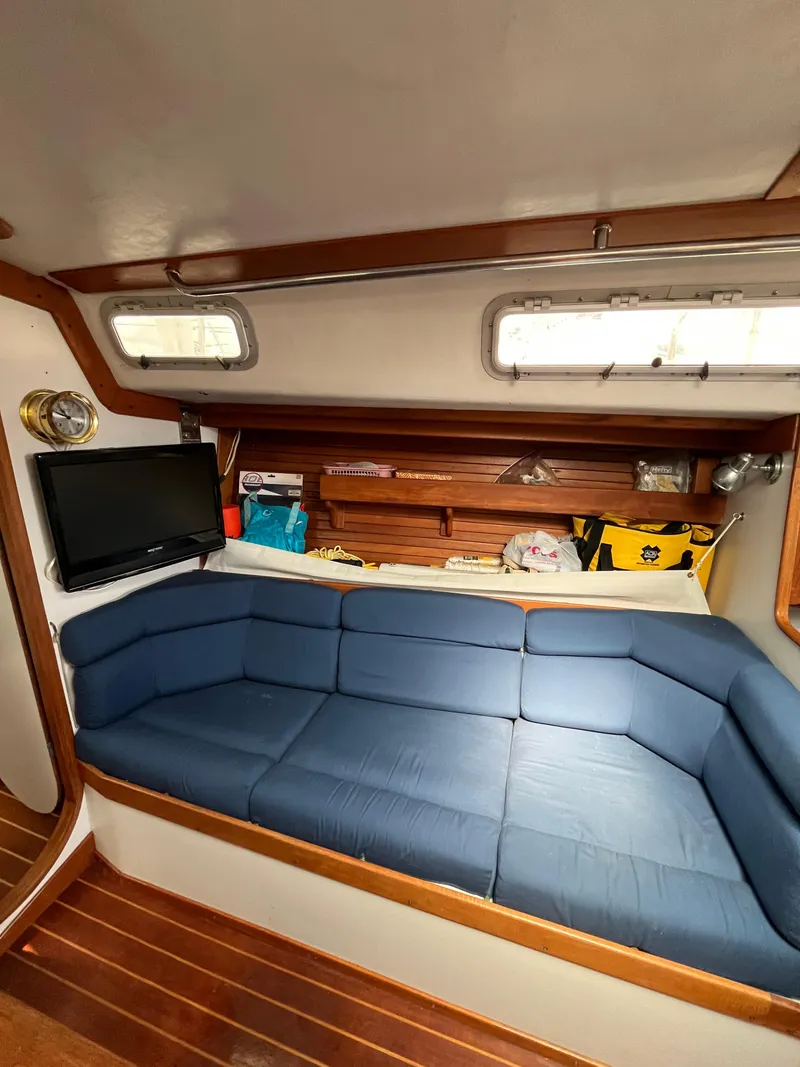 Slide: The Image of Interior of 1994 J Boats J 40 sailboat with blue cushioned seating and wooden accents. - 20