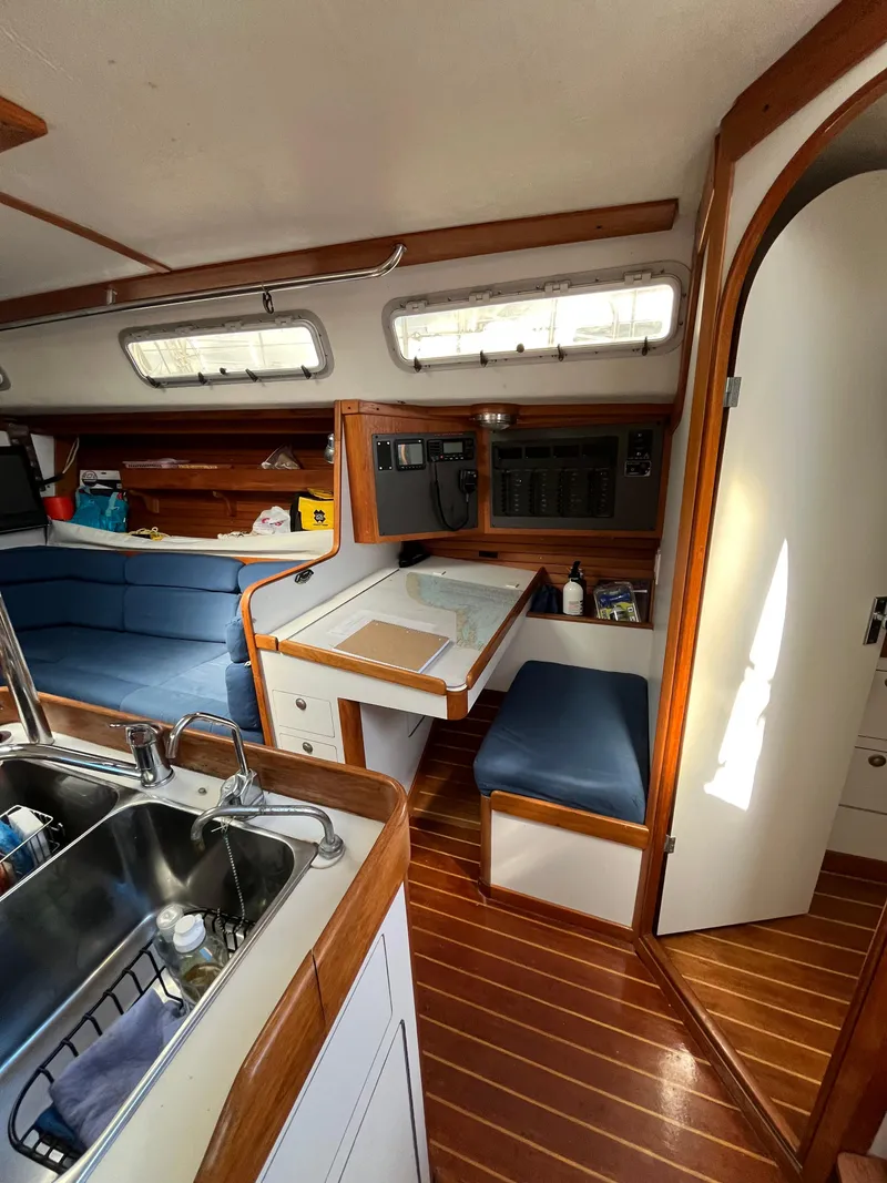 Slide: The Image of Interior of 1994 J Boats J 40 sailboat with wooden accents and blue seating. - 23