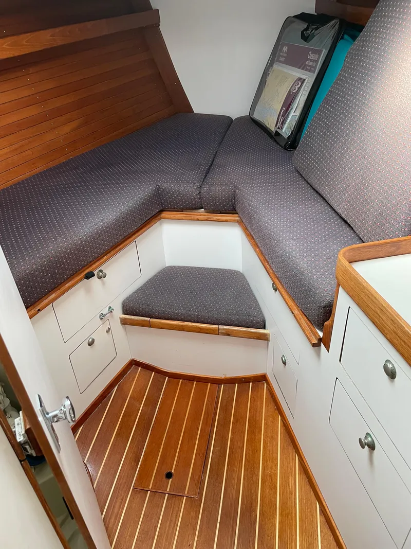 Slide: The Image of Interior cabin of 1994 J Boats J 40 with wooden flooring and cushioned seating. - 25