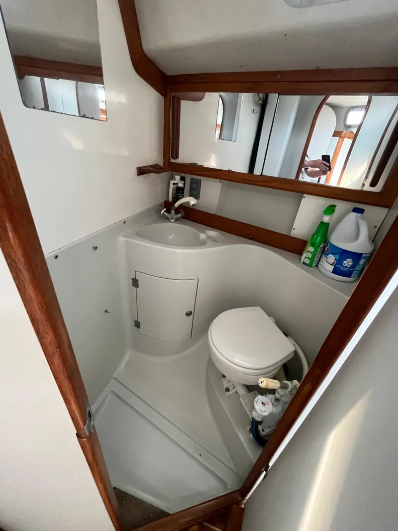 Slide: The Image of 1994 J Boats J 40 yacht bathroom with sink, toilet, and storage cabinet. - 26