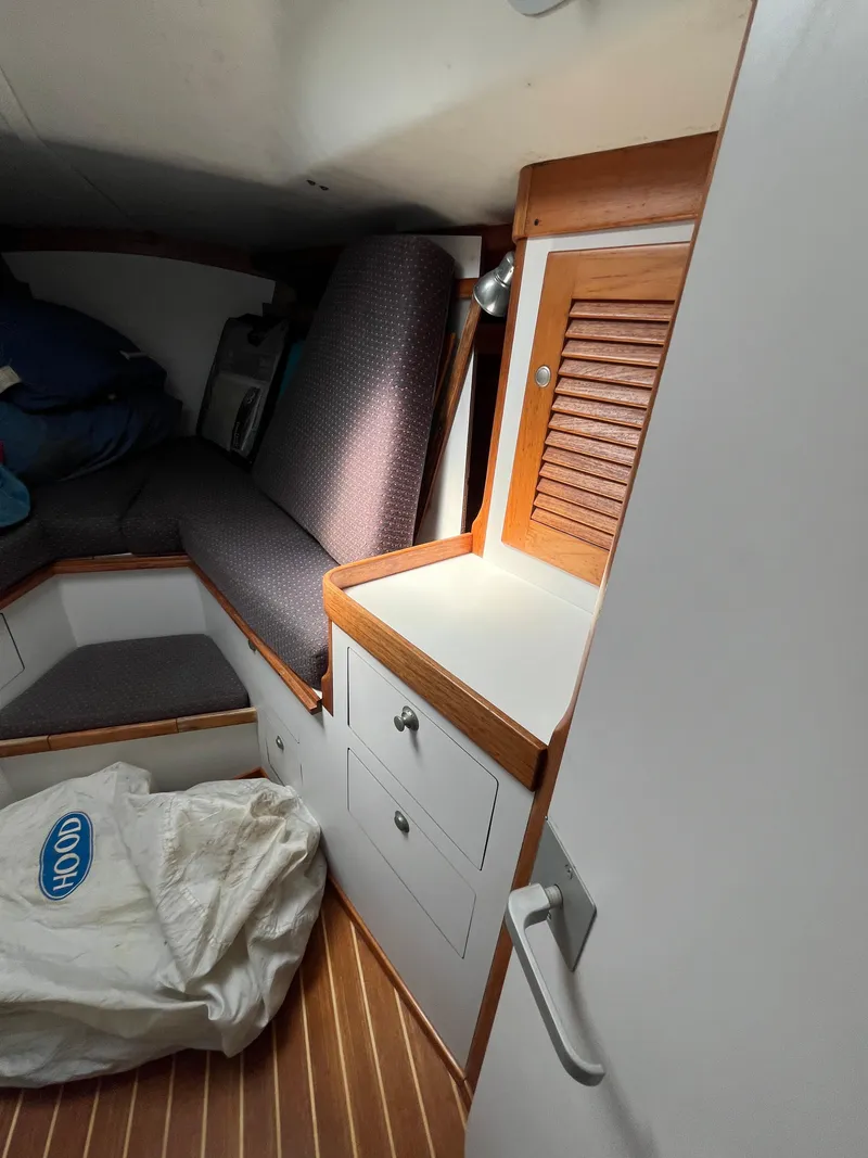 Slide: The Image of Interior cabin of 1994 J Boats J 40 sailboat with wooden accents and storage. - 28