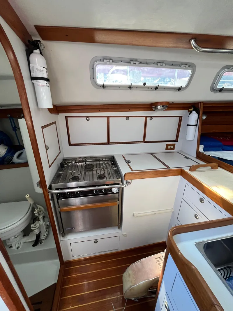 Slide: The Image of Interior of a 1994 J Boats J 40 sailboat, featuring a compact kitchen area. - 30