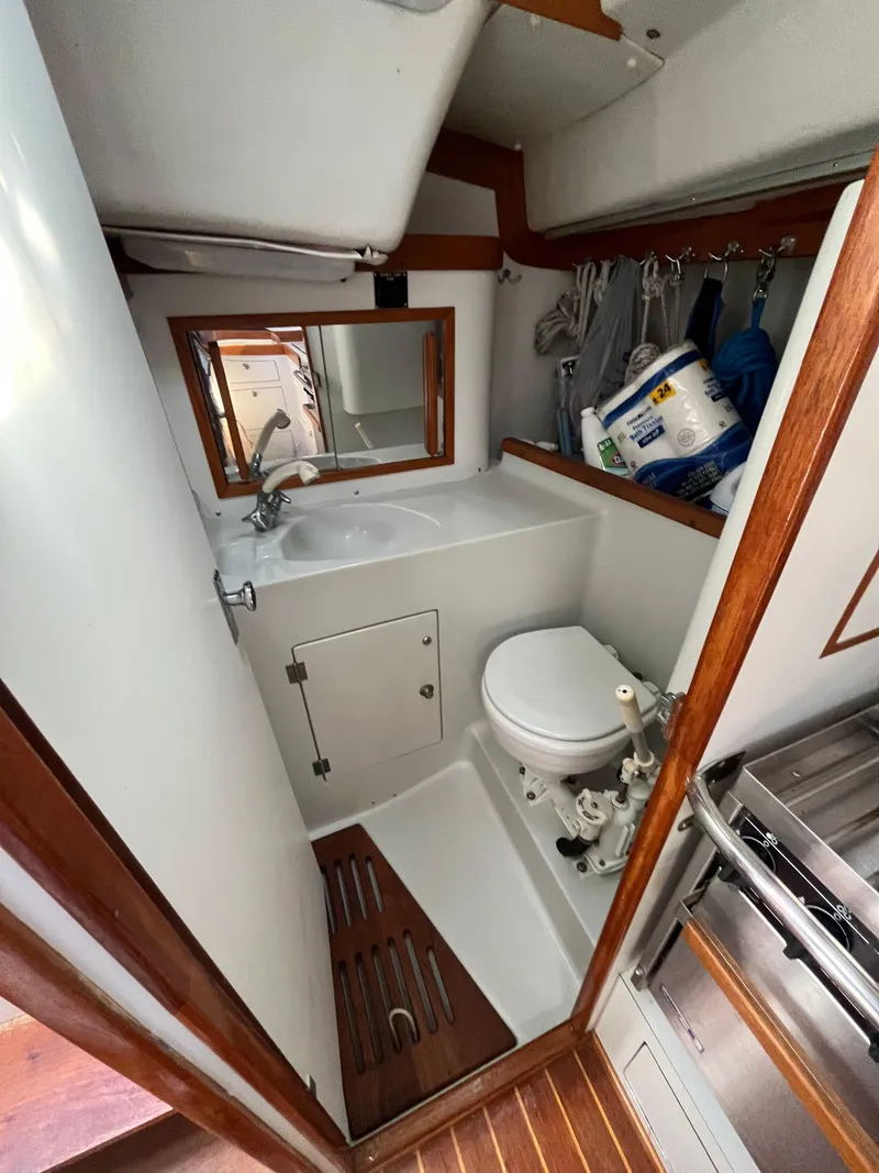 Slide: The Image of 1994 J Boats J 40 yacht bathroom with sink, toilet, and wooden accents. - 31