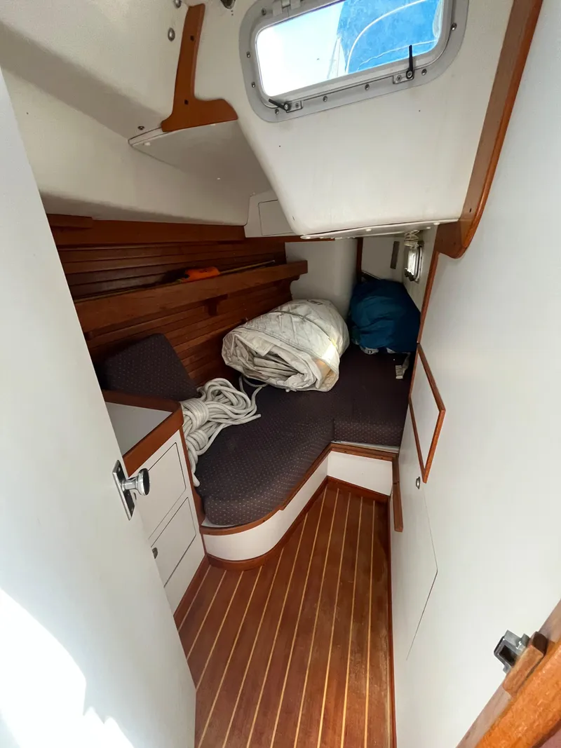 Slide: The Image of 1994 J Boats J 40 cabin interior with wooden flooring and cozy seating area. - 32