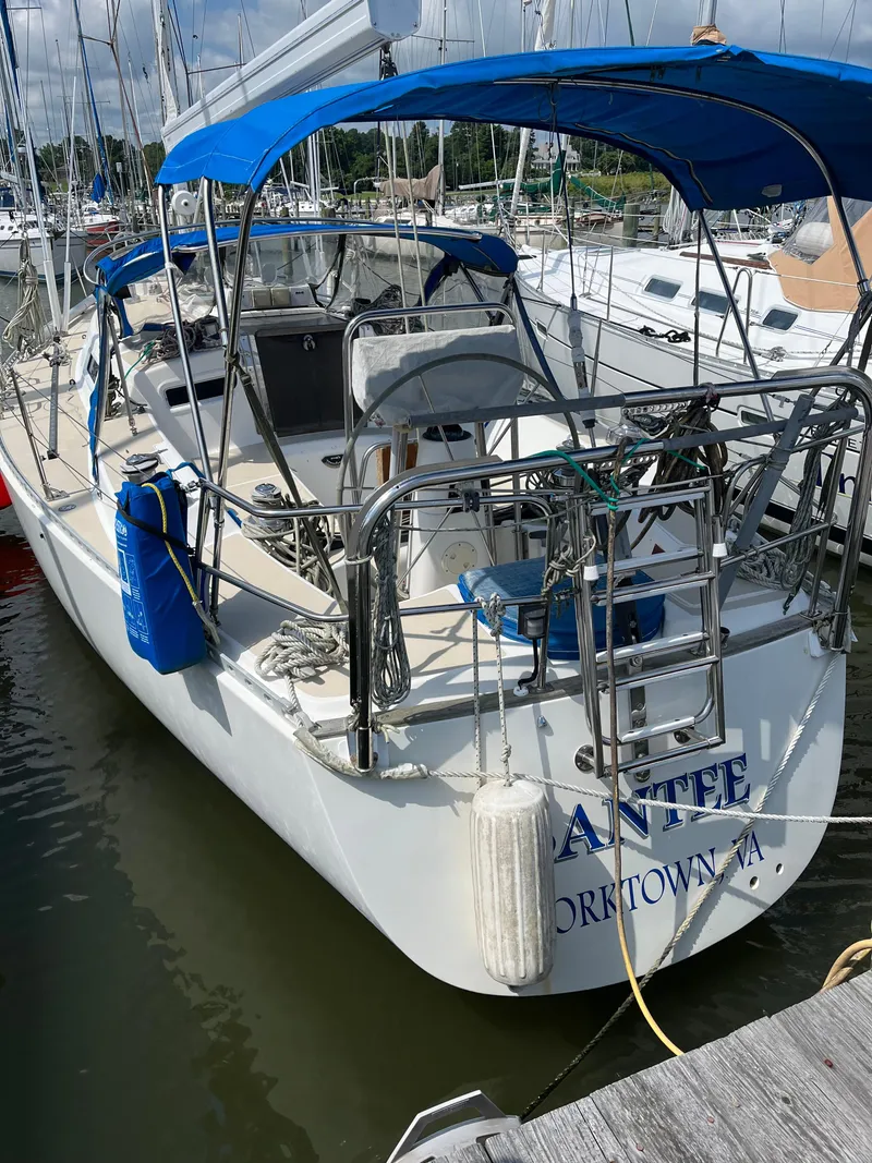 Slide: The Image of 1994 J Boats J 40 sailboat docked, featuring blue canopy and stainless steel railings. - 4