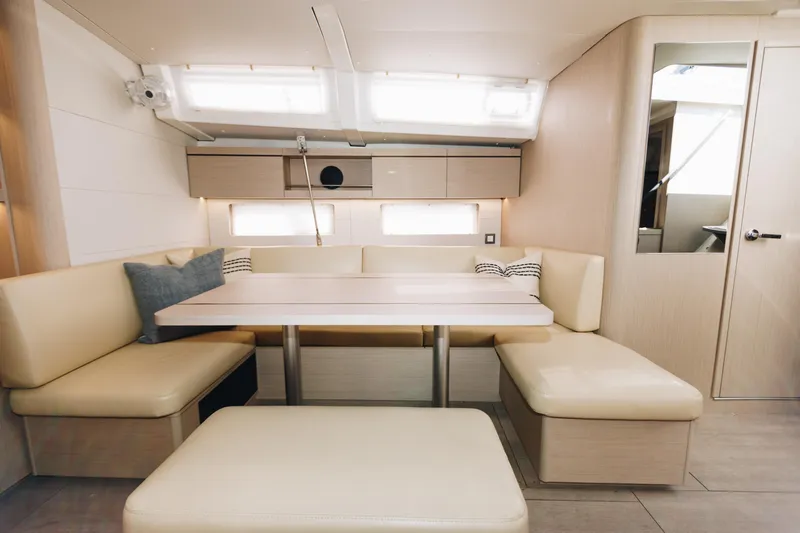 Slide: The Image of 2024 Beneteau Oceanis 46.1 interior with beige seating and modern design. - 10