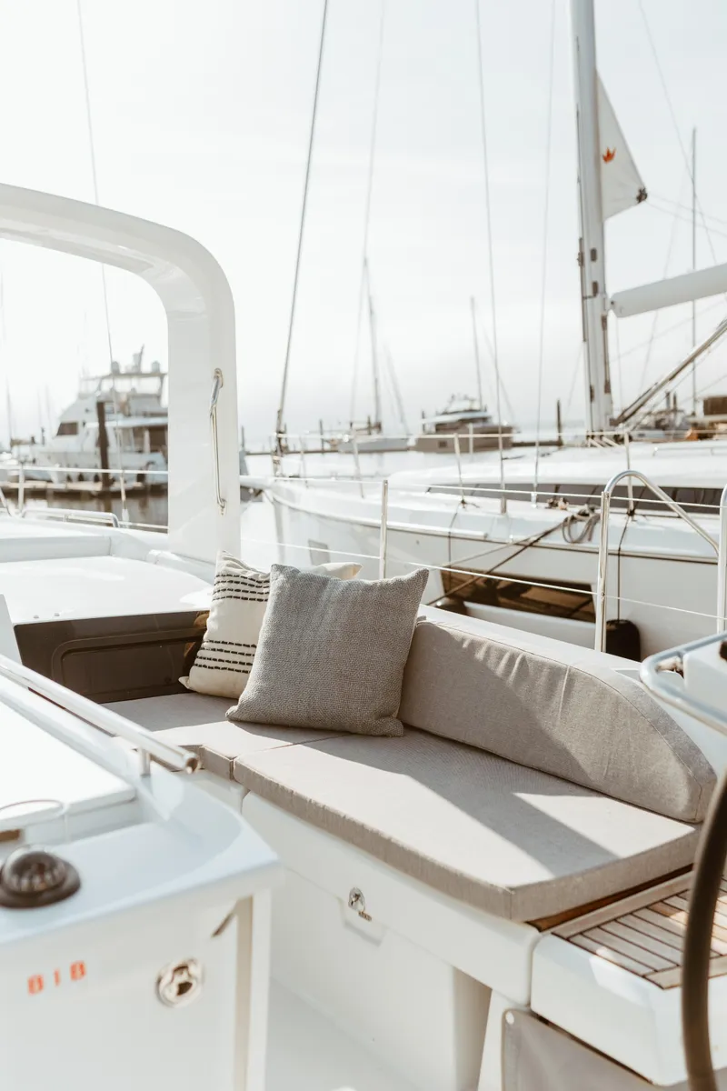 Slide: The Image of 2024 Beneteau Oceanis 46.1 yacht with elegant deck seating and marina view. - 5