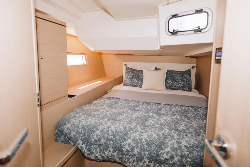 Slide: The Image of 2024 Beneteau Oceanis 51.1 cabin with cozy bed and modern interior design. - 10