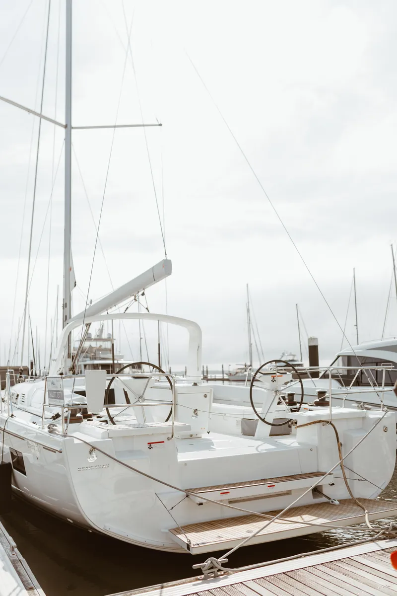 Slide: The Image of 2024 Beneteau Oceanis 51.1 yacht docked at marina, rear view. - 2