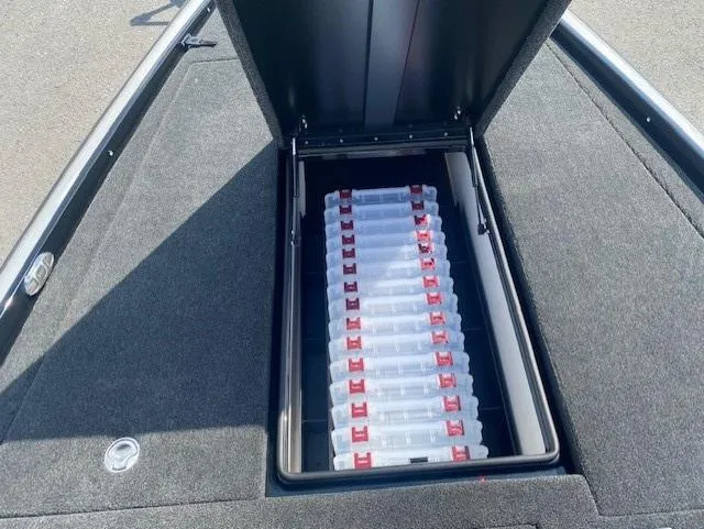 Slide: The Image of Open storage compartment in 2026 Bullet 21XST boat, containing organized tackle boxes. - 10