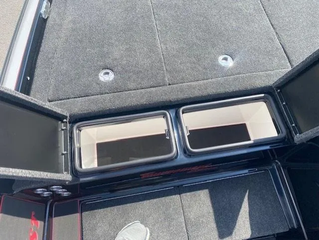 Slide: The Image of 2026 Bullet 21XST boat storage compartments with open lids, showcasing spacious interior. - 13