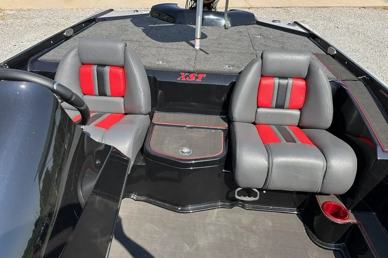 Slide: The Image of 2026 Bullet 21XST boat interior with gray and red seats, steering wheel, and deck. - 19