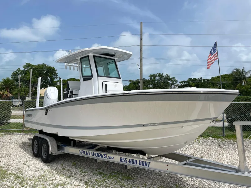 The Image of 2026 Blackfin 262 HB boat on trailer, American flag in background. - 0
