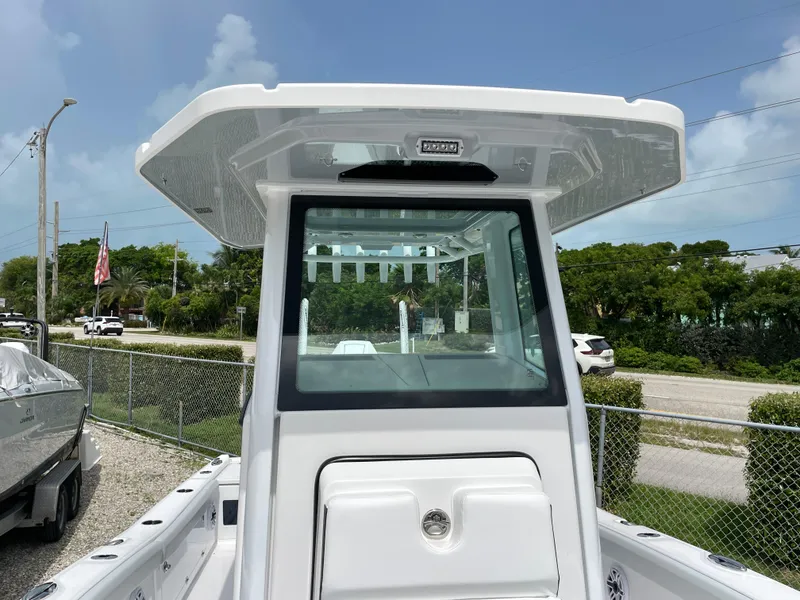Slide: The Image of 2026 Blackfin 262 HB boat with sleek design and modern features, docked outdoors. - 13