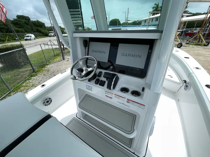 Slide: The Image of 2026 Blackfin 262 HB boat helm with dual Garmin displays and steering wheel. - 16