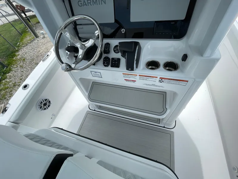 Slide: The Image of 2026 Blackfin 262 HB boat helm with Garmin display and steering wheel. - 17