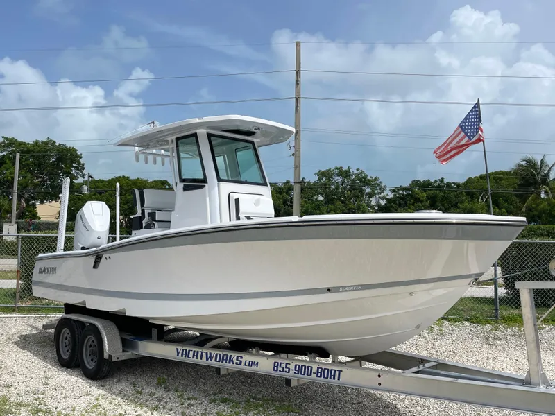 Slide: The Image of 2026 Blackfin 262 HB boat on trailer with American flag in background. - 2
