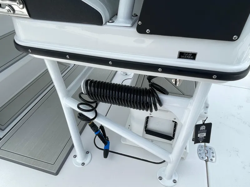 Slide: The Image of 2026 Blackfin 262 HB boat deck with coiled hose and raw water label. - 26