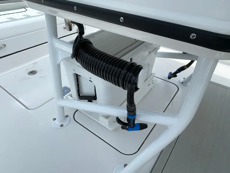 Slide: The Image of 2026 Blackfin 262 HB boat deck with coiled hose and storage compartment. - 27